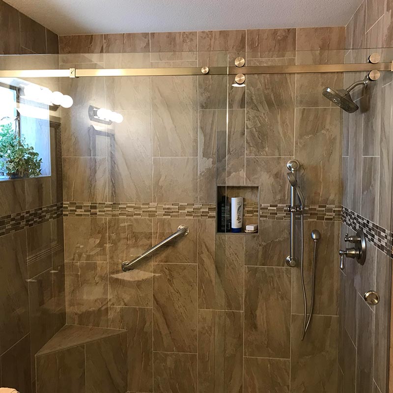 bathroom after remodel with glass and tile shower