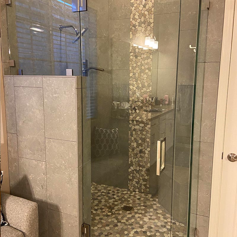 Shower with glass doors and beautiful tile after remodel.