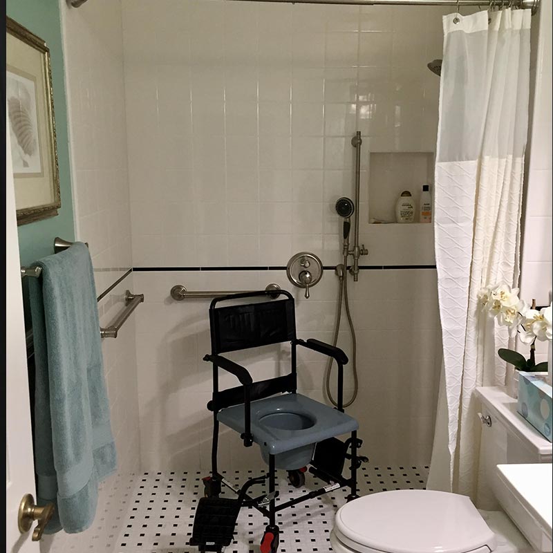 Bathroom that is remodeled with walk-in shower, hand rails, and accessible controls